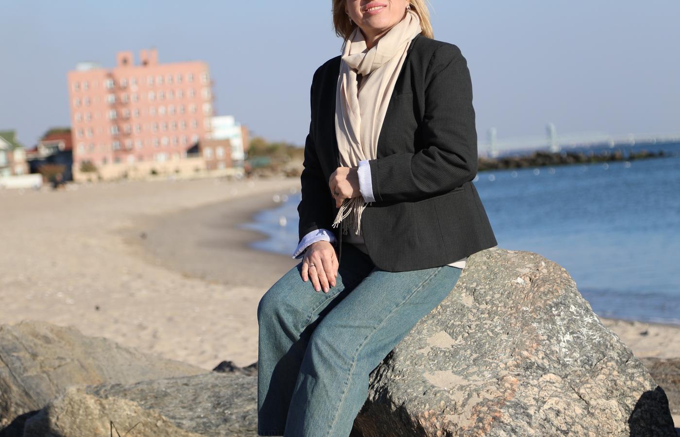 Woman seated on the sand beside the Atlantic Ocean in New York